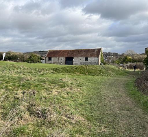 Grade II listed Benfield Barn forms part of the site 